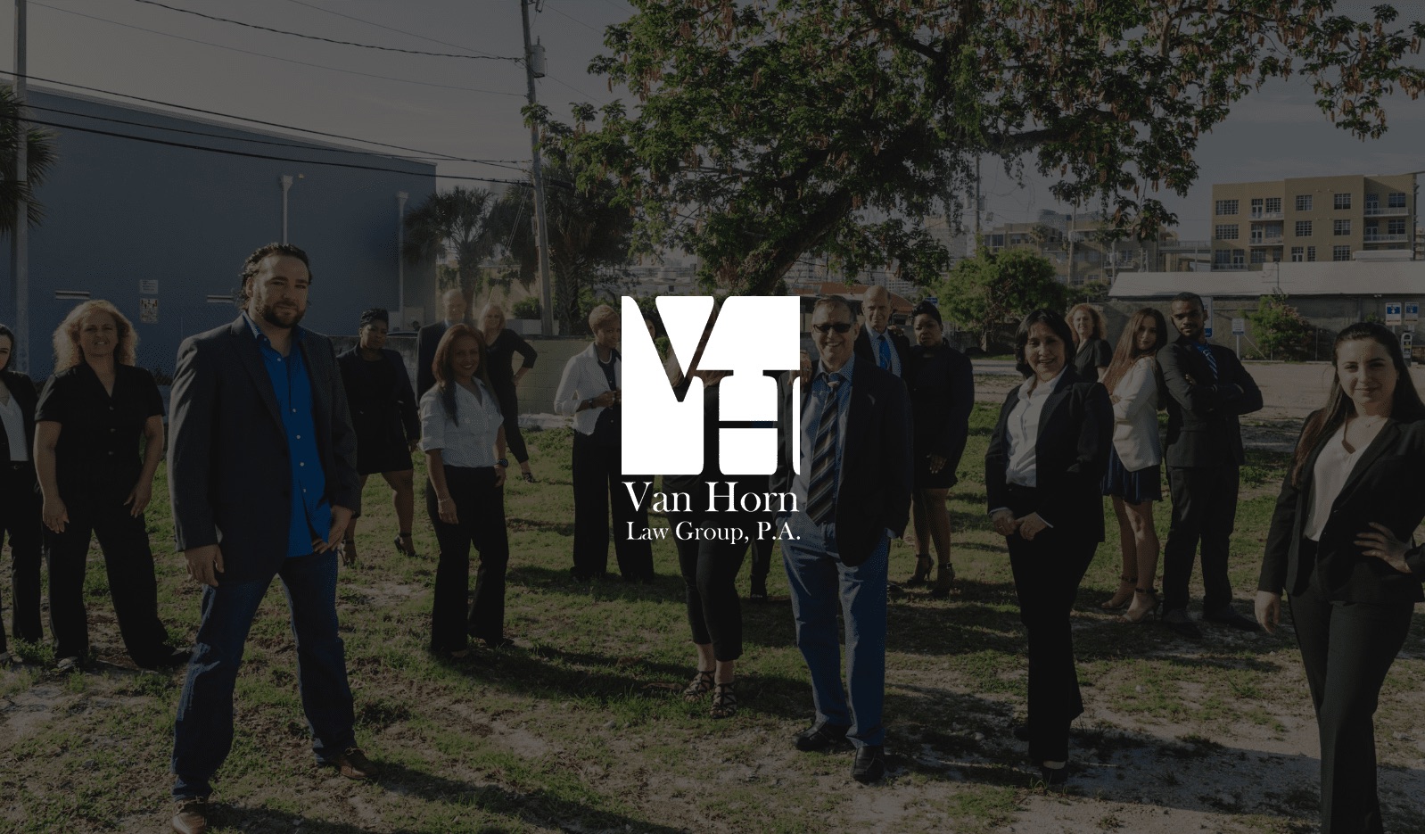 VH Van Horn Law Group P.A. Stacked Logo small with a group photo as a backdrop