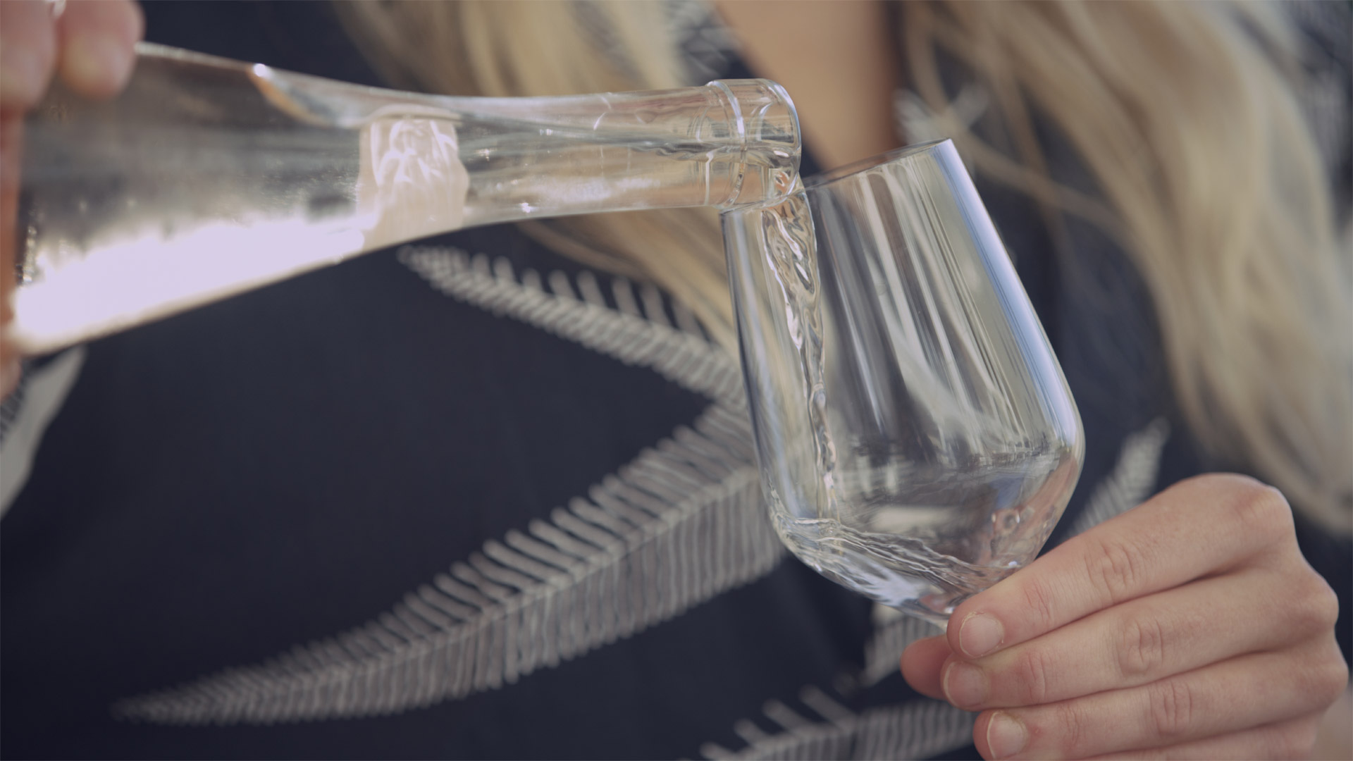 Closeup of a drink being poured into a glass