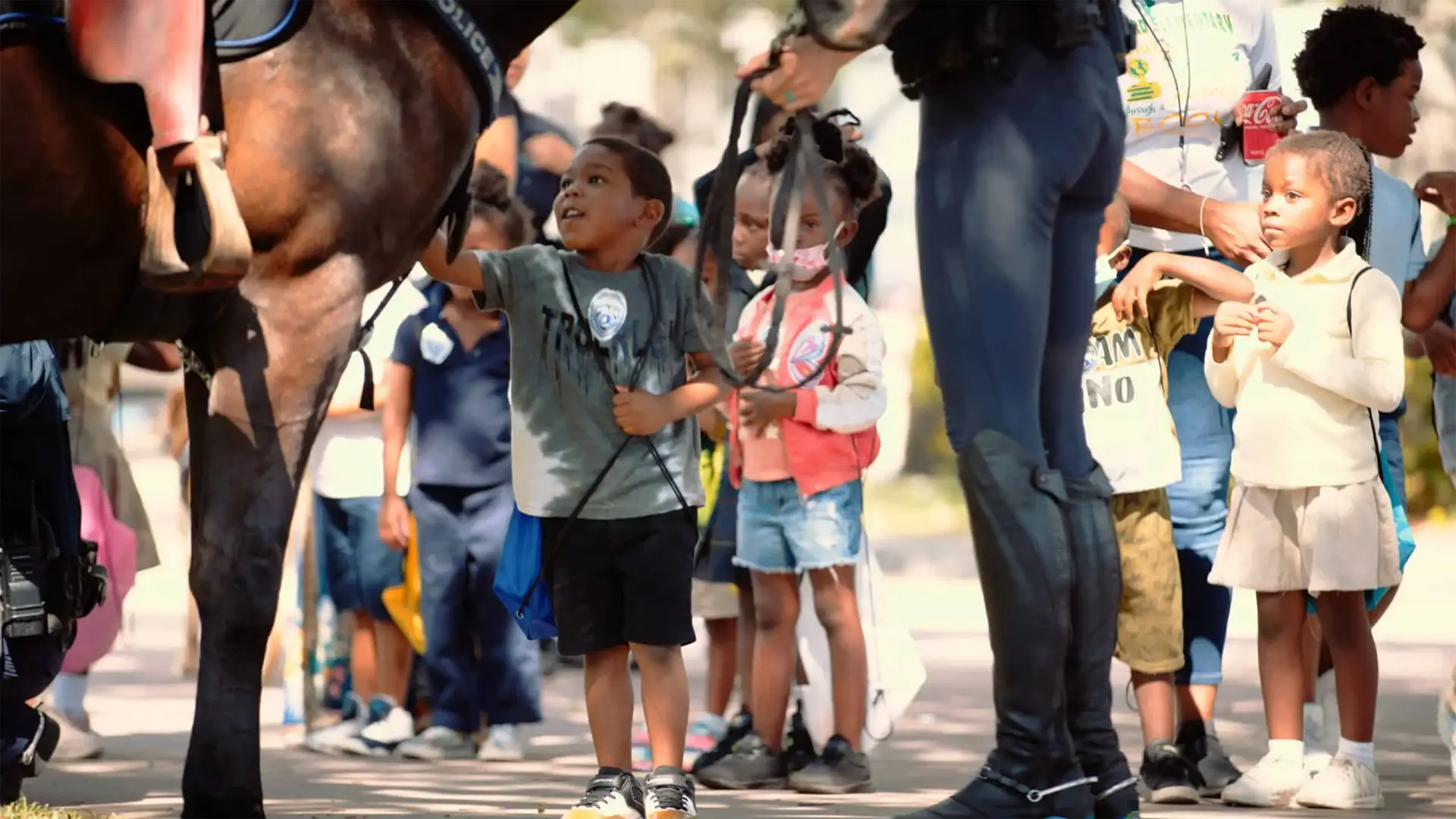 Ranger Technical Resources 33 Children standing around with one boy petting a police horse