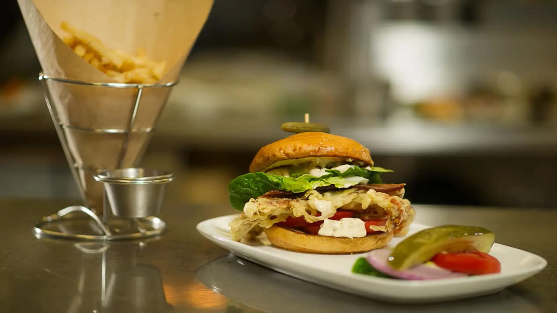 Gold Coast Magazine 70 Closeup of french fries and burger with pickle and tomato