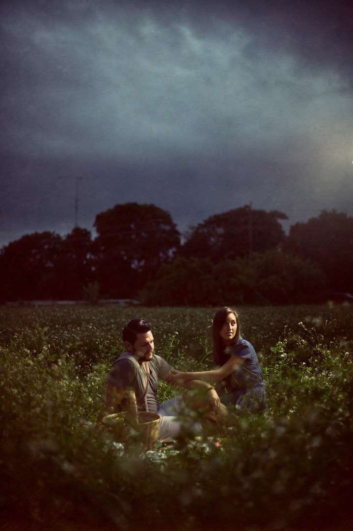 Uncreative Blog Man and woman sitting in a field with a woven basket nearby