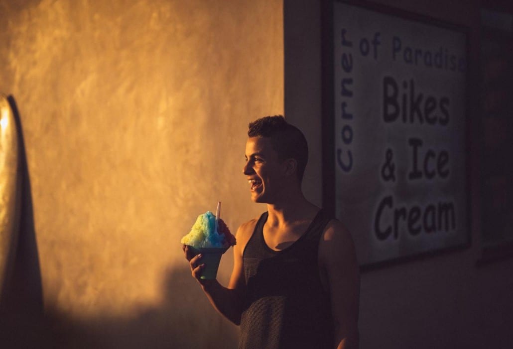 Ivivva Lulu Lemon Young man smiling holding a large ice cone by an ice cream store