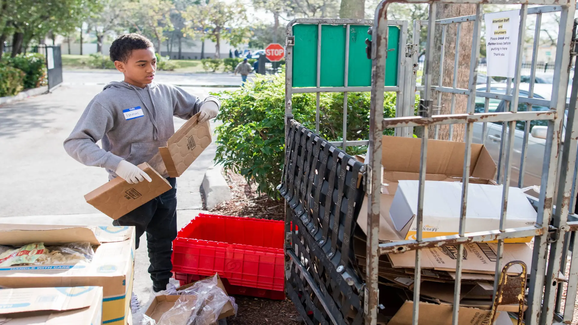 United Way 219 Boy putting cardboard in recycling area