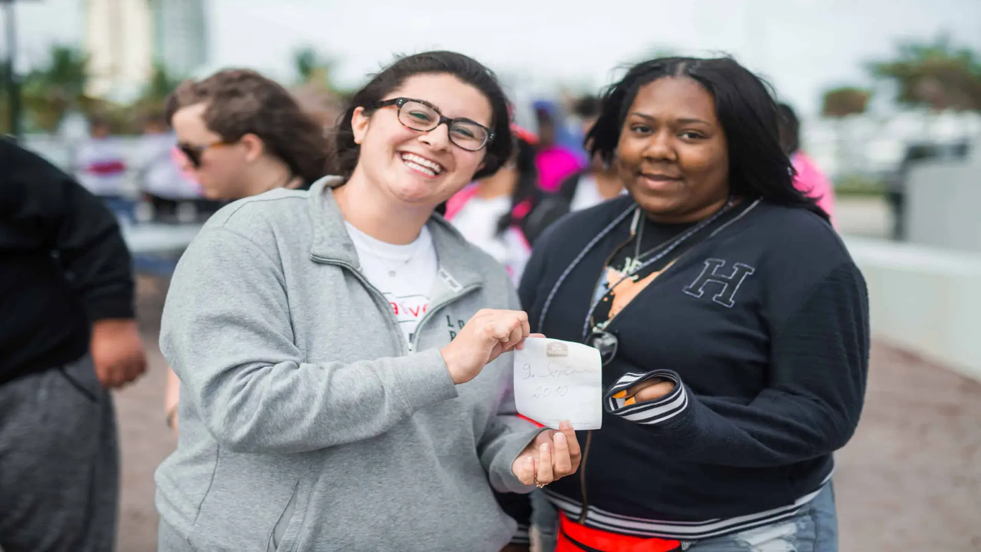 United Way 228 Two women posing for camera holding a note