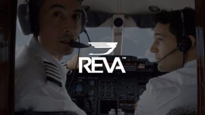 REVA Air Ambulance White Reva logo against background of two pilots in the cockpit