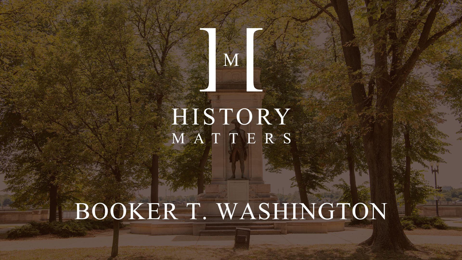 History Matters Booker T. Washington by Laurie Menekou with background of an old monument in a park