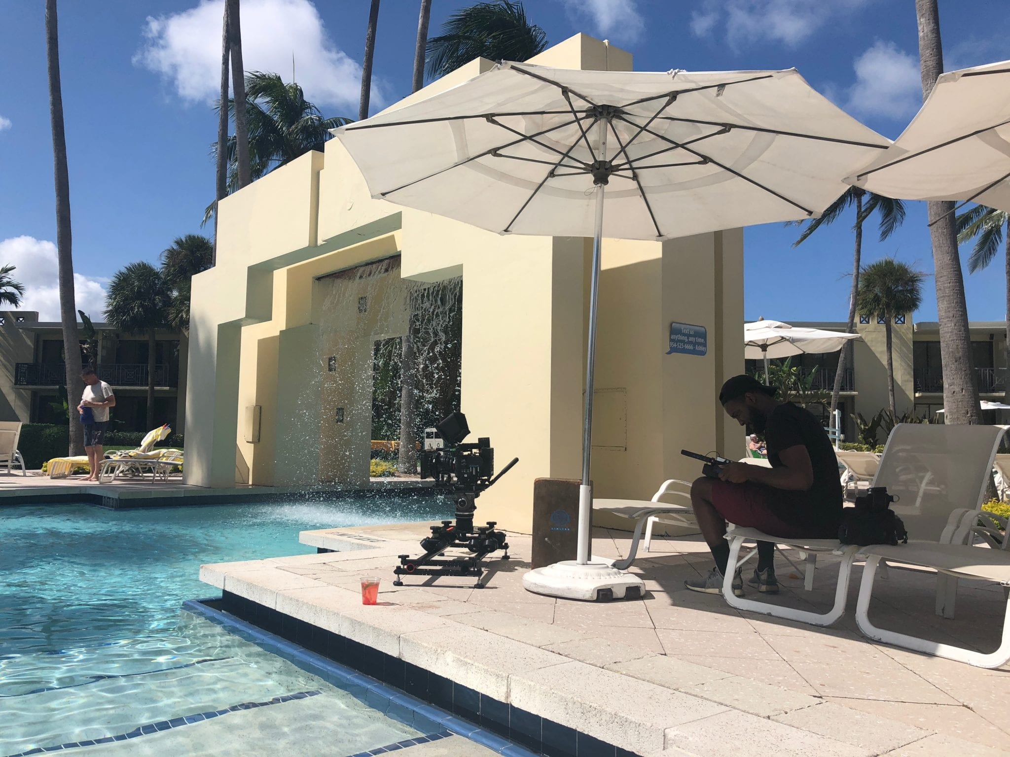 Pier Sixty Six Storyboard Video cameraman setting up equipment on a pool patio at a hotel