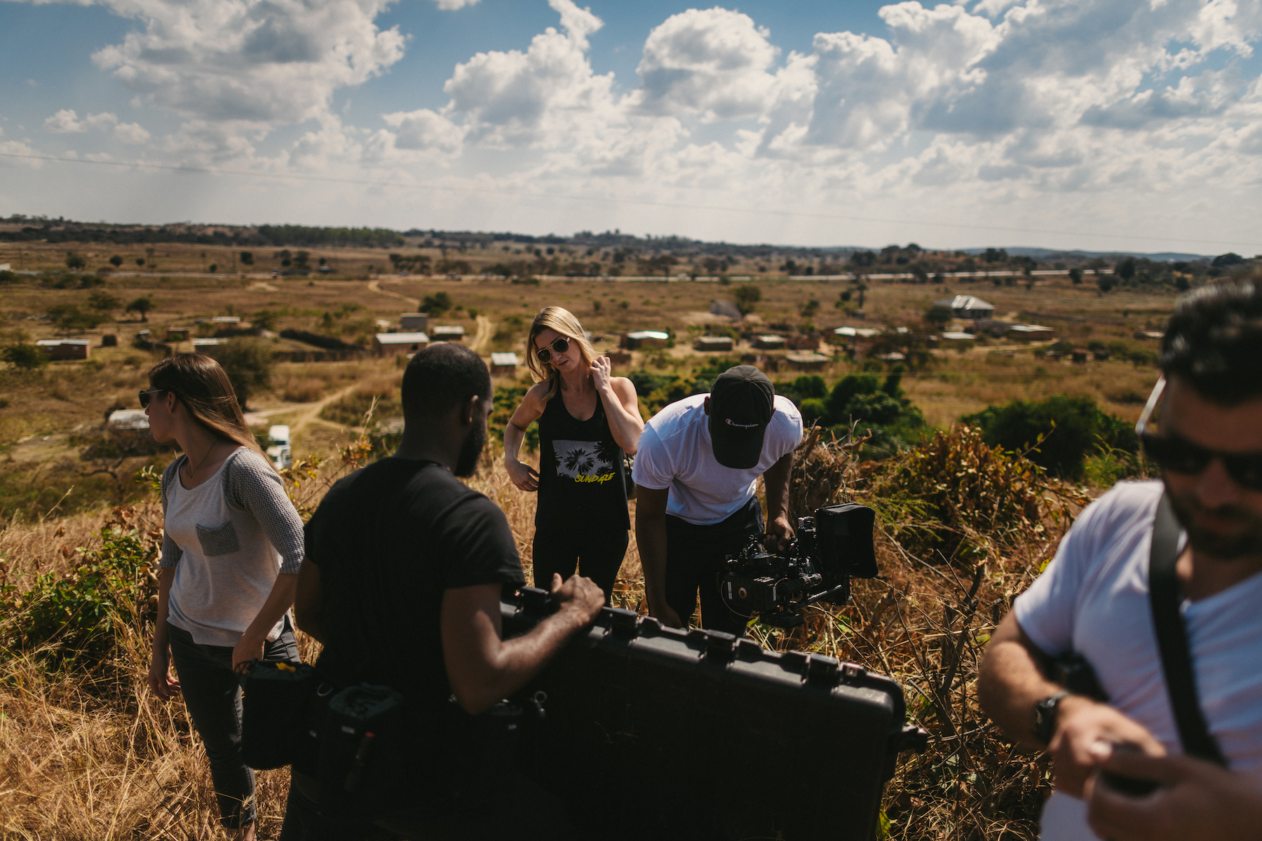 JSM Three men and two women getting video equipment set up in a field
