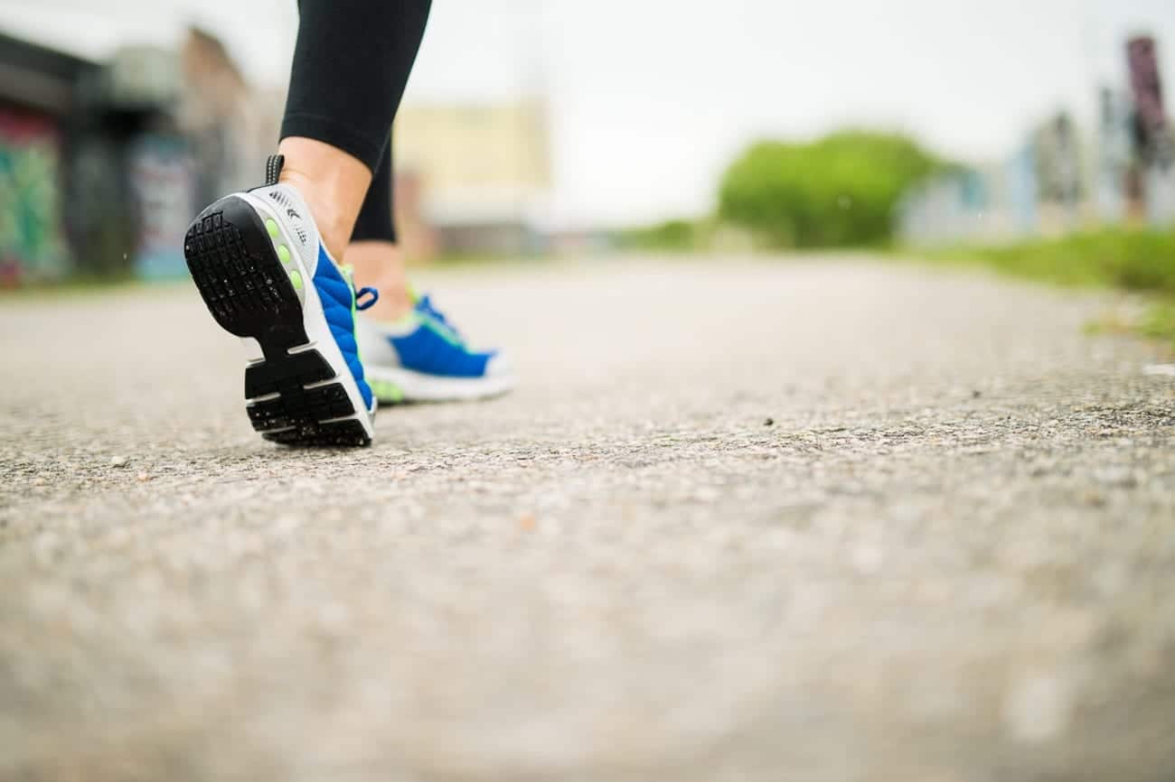 Closeup of women's Therafit Shoes that are mostly blue with light green inserts throughout along with black soles.