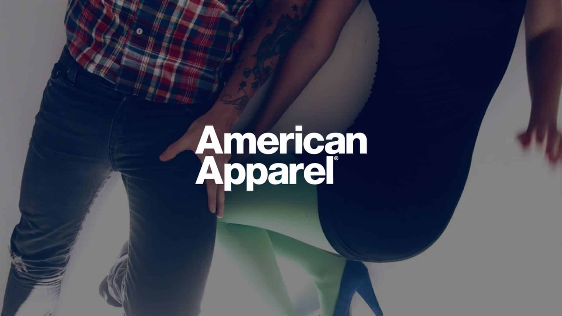 Closeup of lower halves of man and woman posing for camera for American Apparel with logo.
