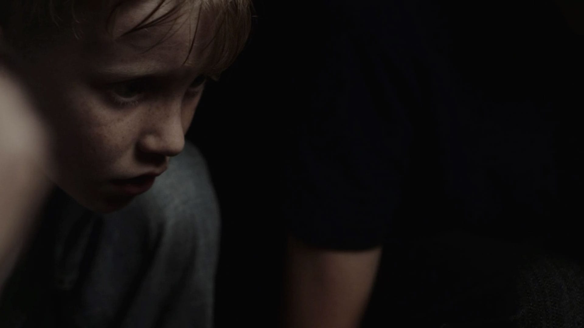 Boy with freckles looking off camera