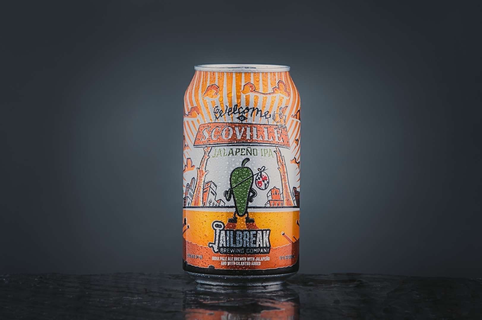 Closeup of a mostly orange colored can of "Scoville Jalapeno IPA" drink made by Jailbreak Brewing Company.