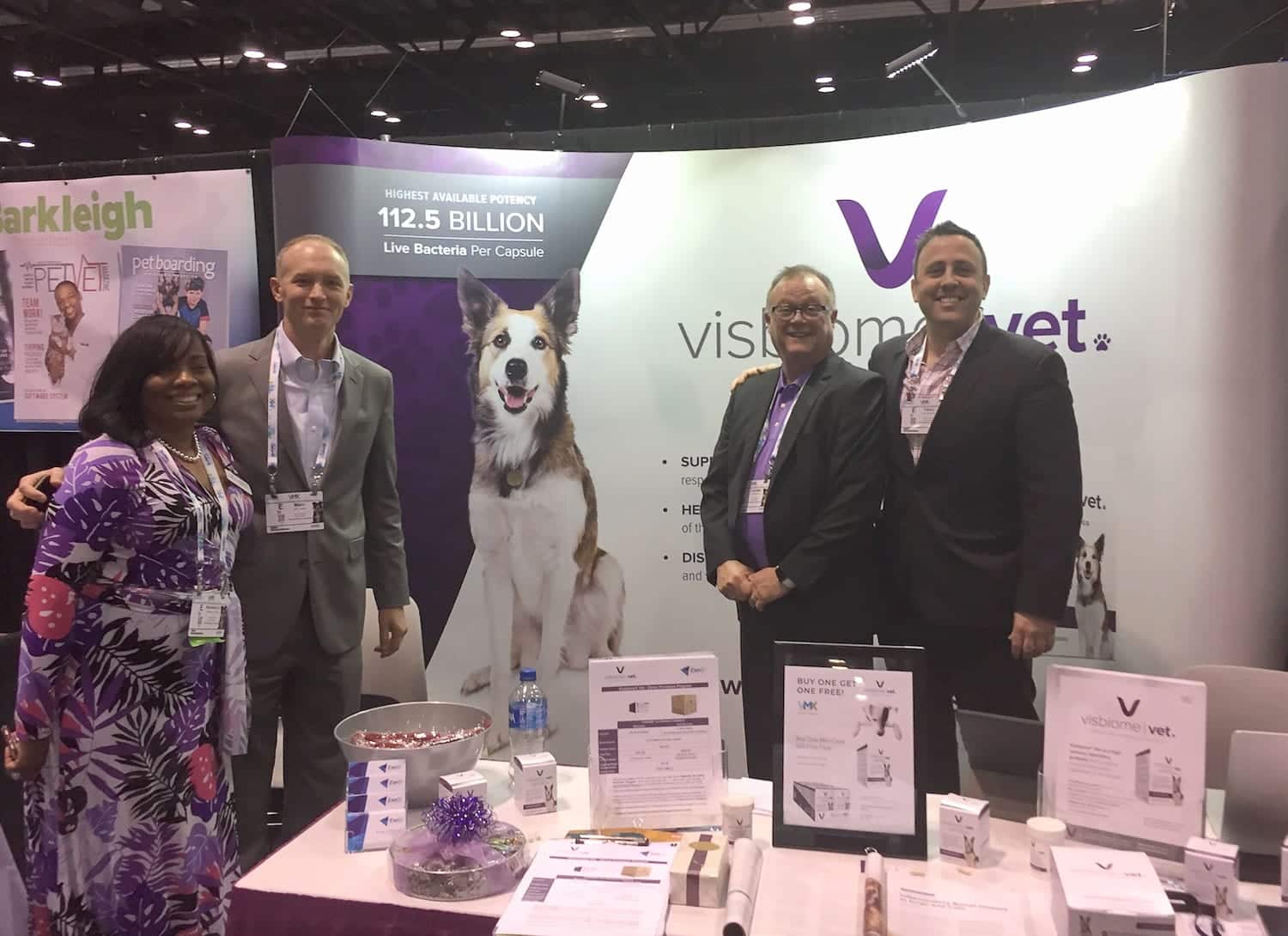 Visbiome booth Booth for Visbiome Vet for High Potency Pet Probiotics with a woman and three men posing for a camera with promotion materials.
