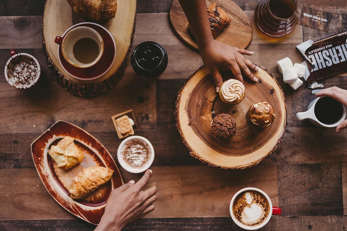Social Media Marketing today Facebook drops some news Social media marketing C&I studios Image Table spread of various desserts with various types of coffees, and smores ingredients.