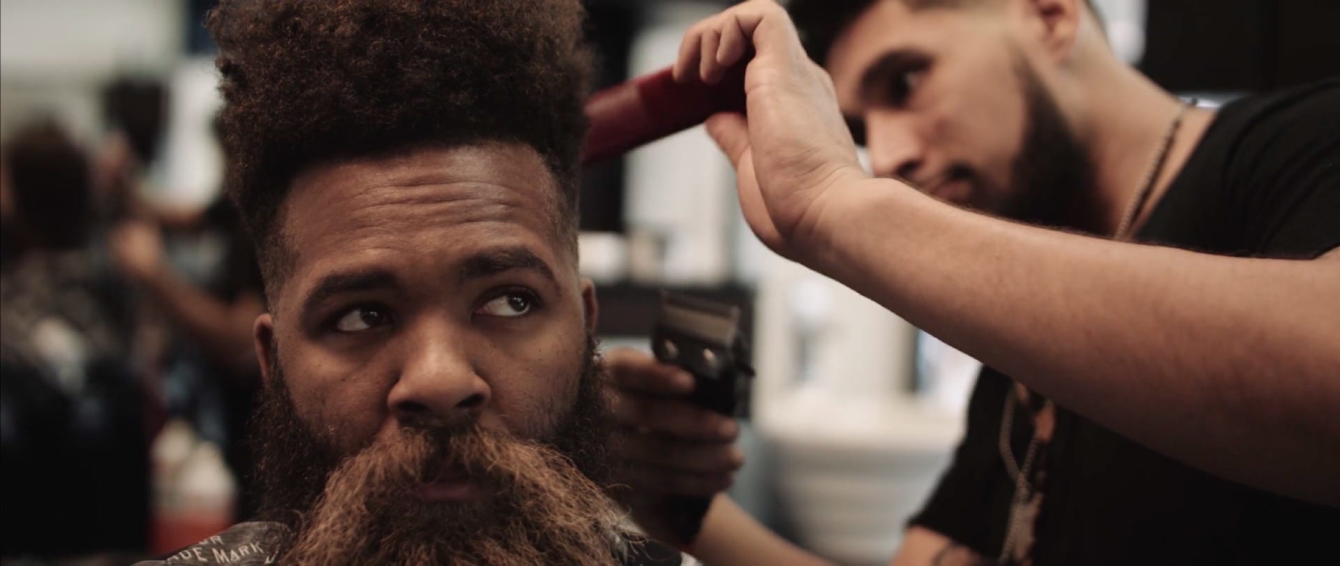 Brandon Baker Beard Project African American man getting hair cut by a barber