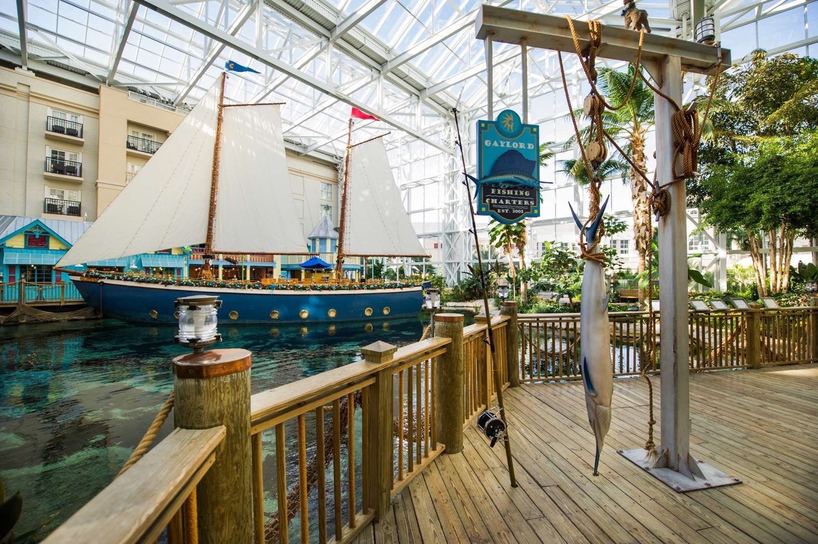 Gaylord Palms Resort and Convention Center Interior showing a marine themed area with a small ship, fishing rod and replica of hanging marlin fish.