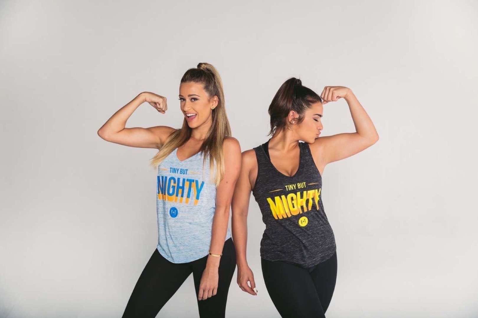 Nicole Mejia's Thick + Fit Two young women in loose tops and spandex tights posing for camera showing their muscles