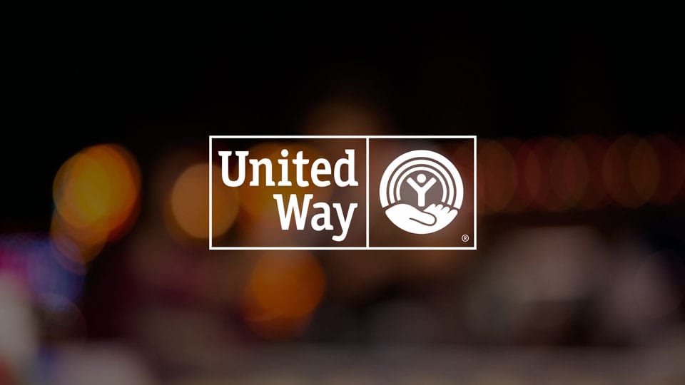 White logo of United Way against black background