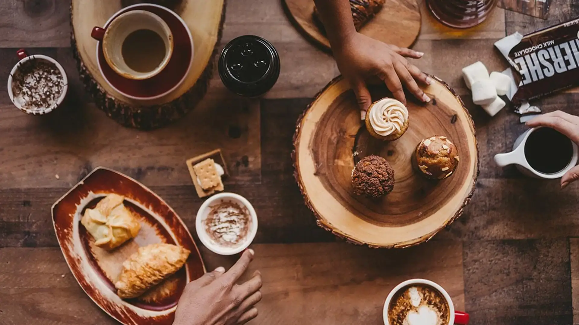 post-social-media-marketing-today-facebook-drops-some-news3 Social media marketing C&I studios Image Table spread of various desserts with various types of coffees, and smores ingredients.