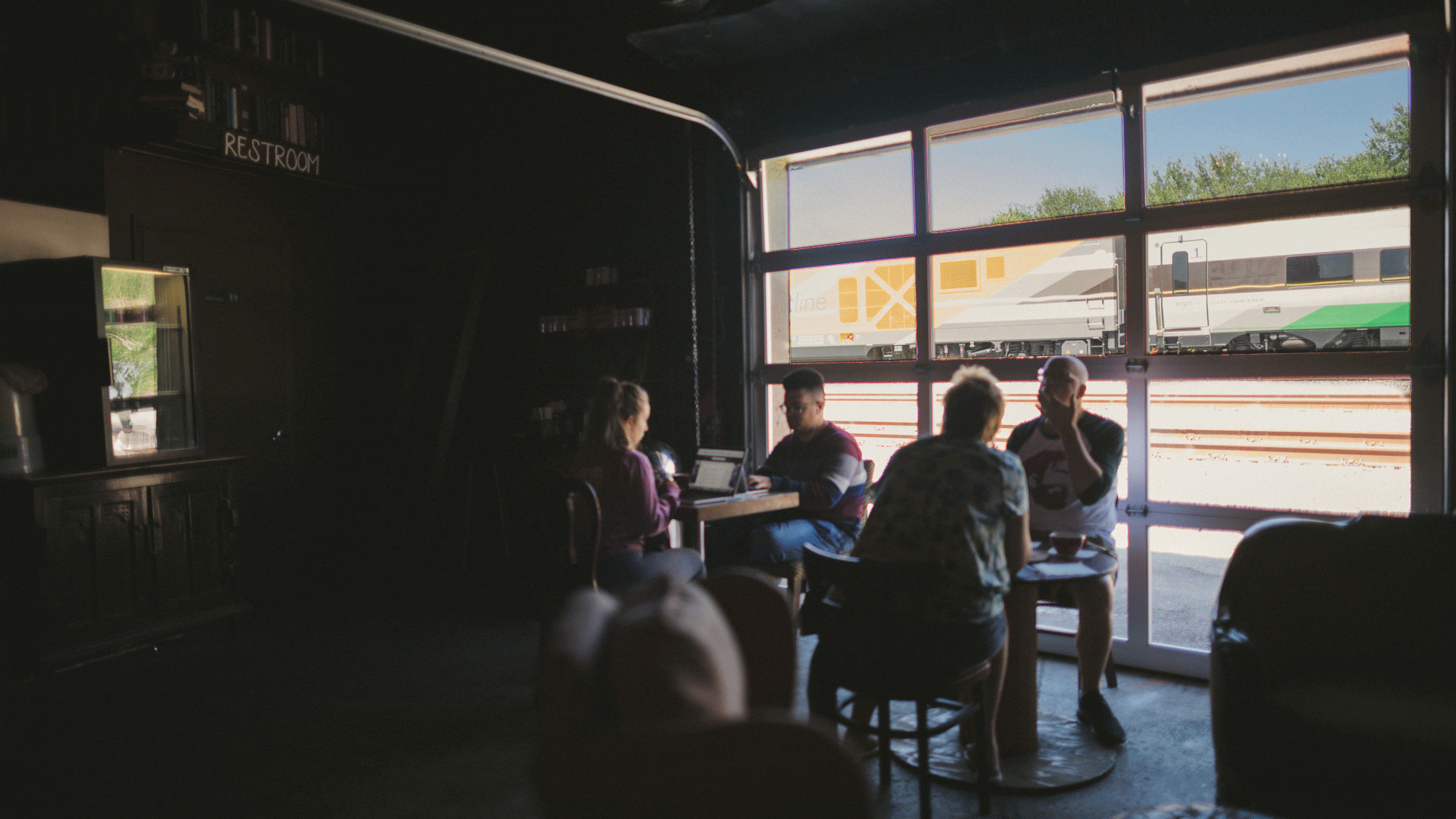 Interior view of Brew Urban Cafe with train passing outside
