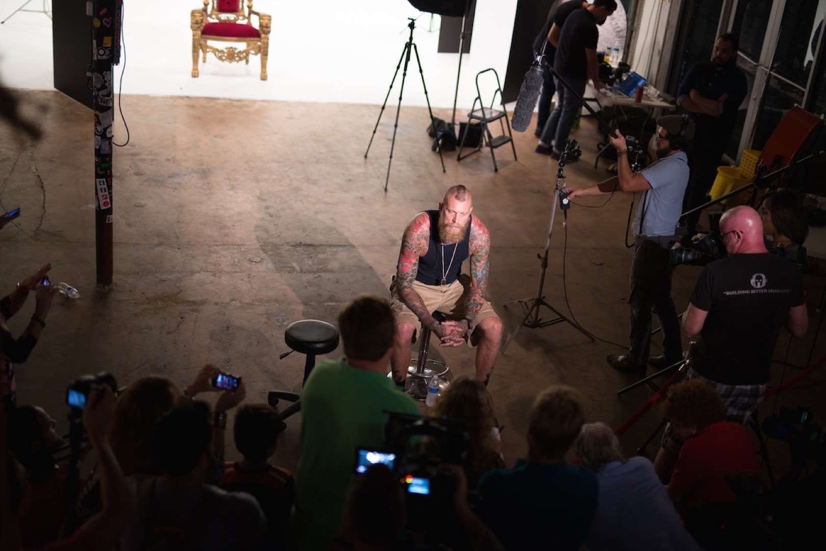 Tattooed man with mohawk posing for camera man and crew