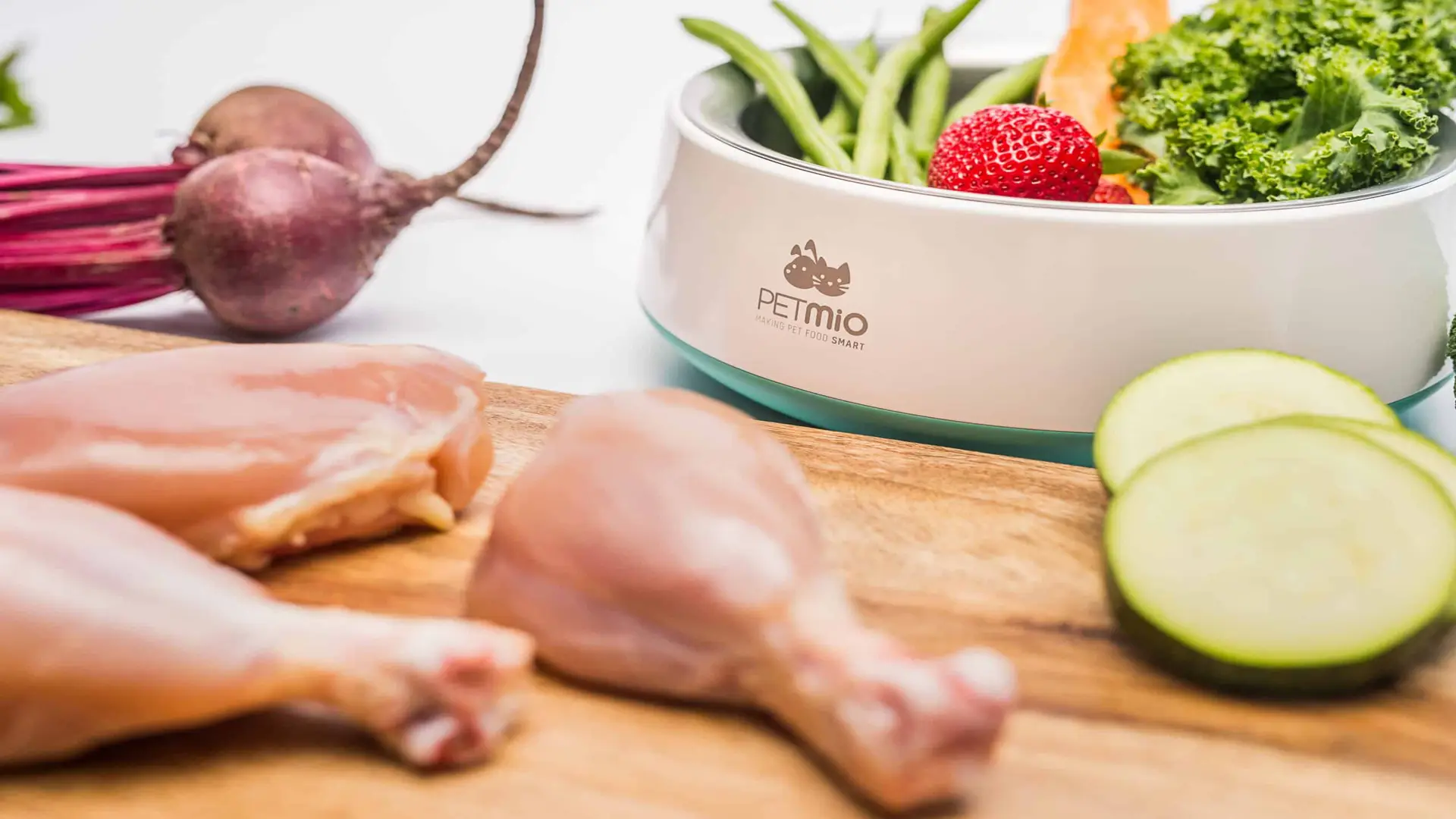 PetMio 111 Closeup of raw chicken withe various vegetables on display with Petmio bowl