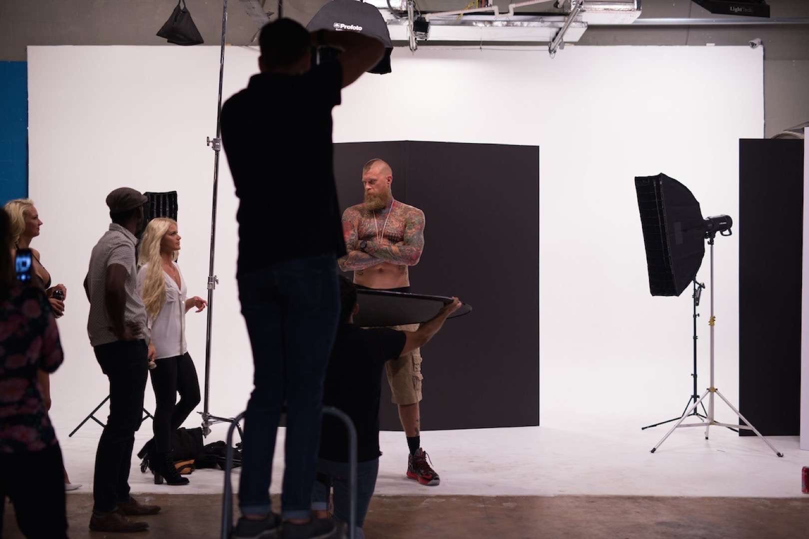 IU C&I Studios Portfolio Hard Rock Energy BTS Tattooed man with mohawk posing for camera man and crew
