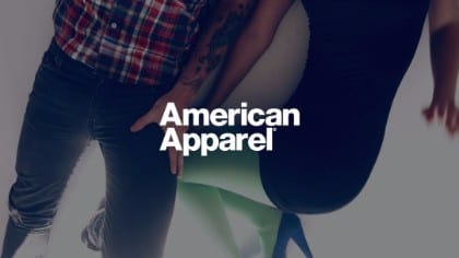 White American Apparel logo against backdrop of a man next to woman