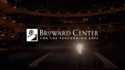 White Broward Center for the Performing Arts logo with a lit lightbulb on a stage
