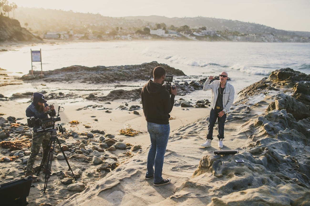 Facebook Live Video Man being videographed on a beach by two videographers