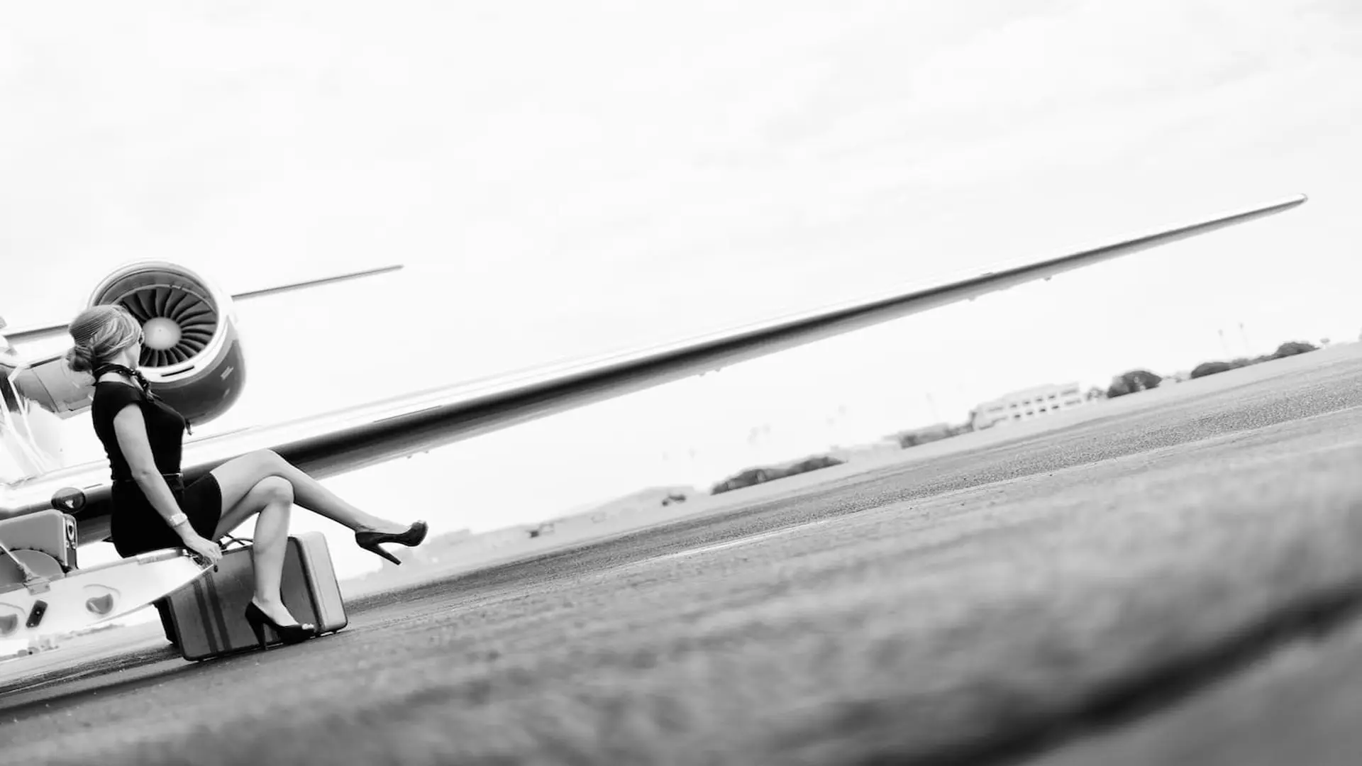 post-facebook-story-ads-social-media-marketing6 Black and white side profile of woman sitting near a plane