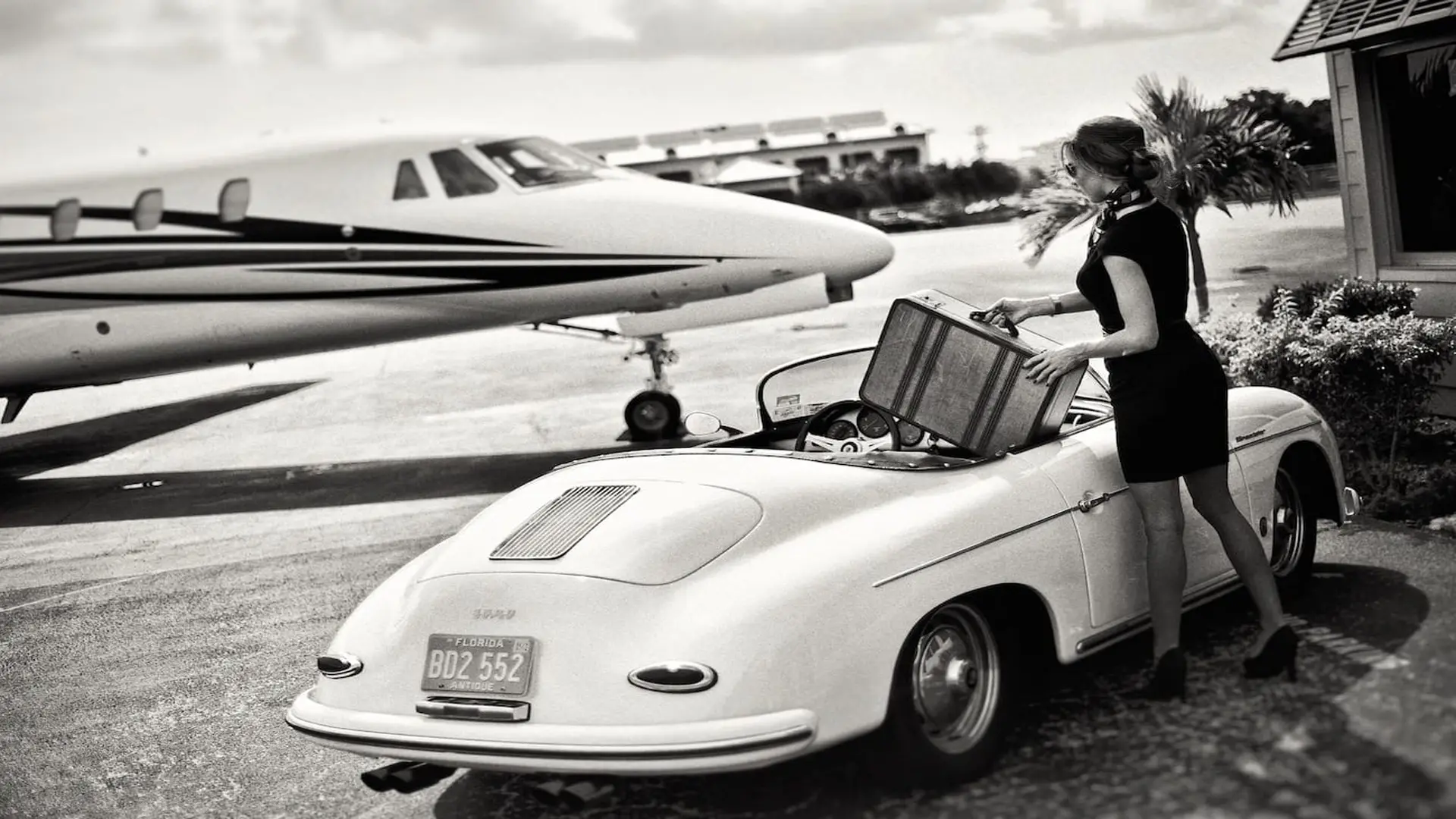 post-facebook-story-ads-social-media-marketing7 Black and white side profile of woman putting suitcase in a car