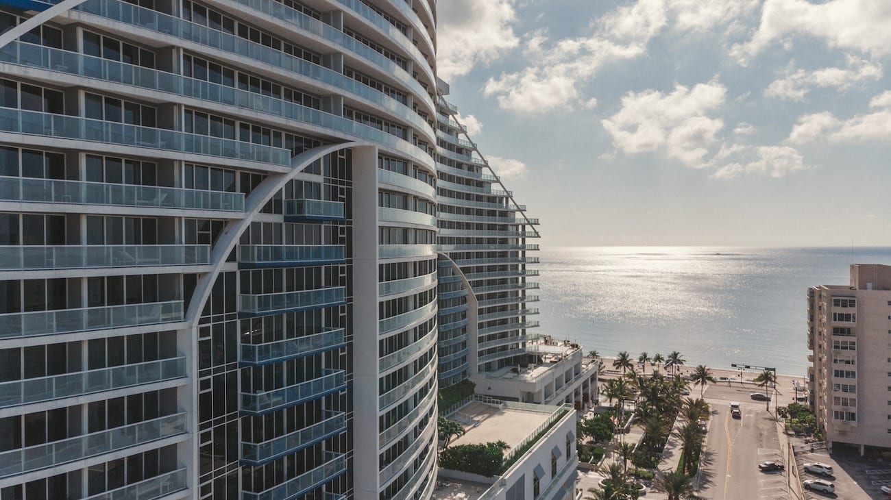 W Fort Lauderdale Residences Marketing Solutions by C&I An Idea Agency Side view of apartment complex with view overlooking the beach