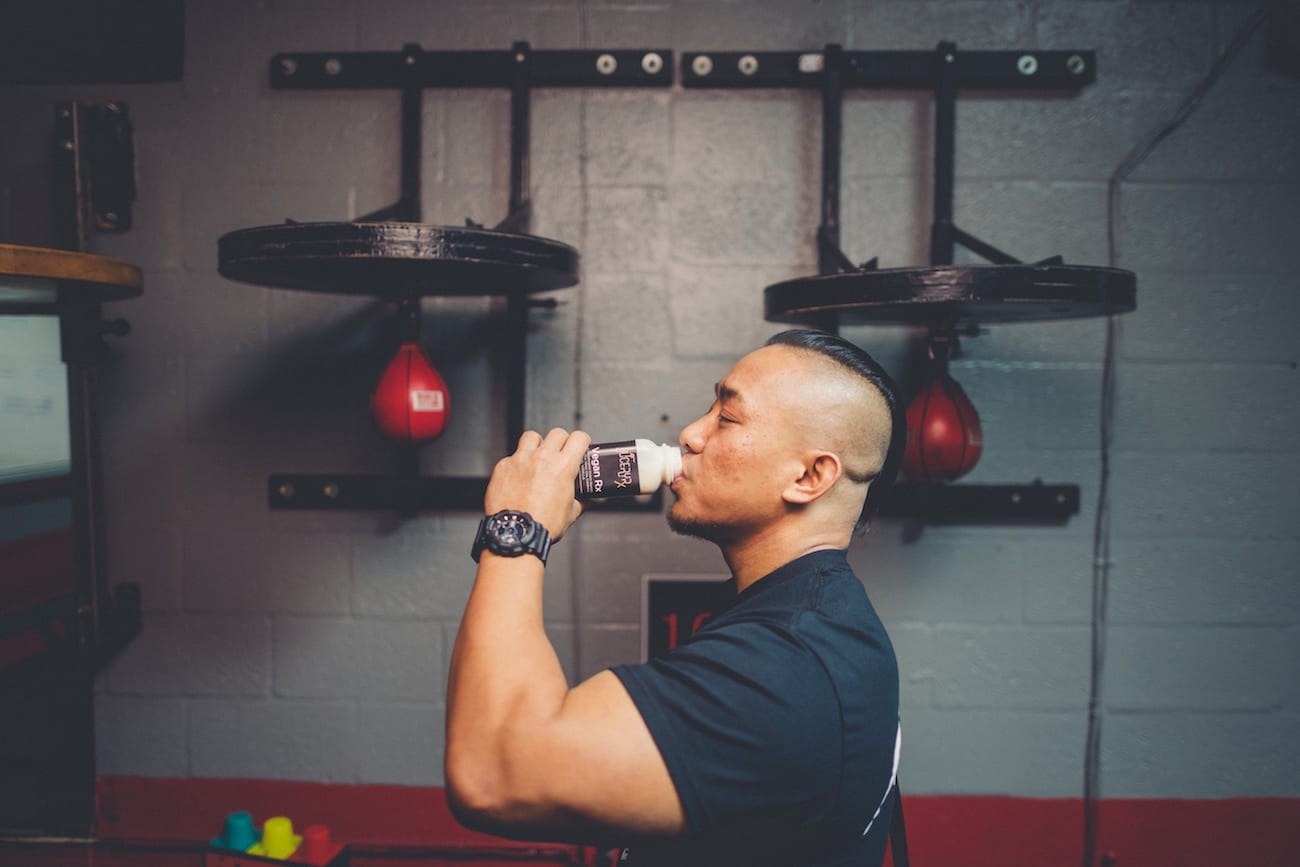 Juicery RX Marketing Solutions by C&I An Idea Agency Muscular man drinking Vegan Rx from plastic container in a gym