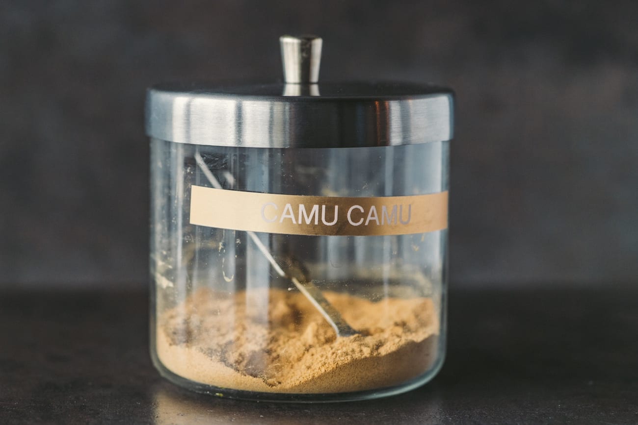 IU C&I Studios Portfolio JuiceryRx Marketing Solutions by C&I An Idea Agency Camu Camu powder in a glass container with a scoop