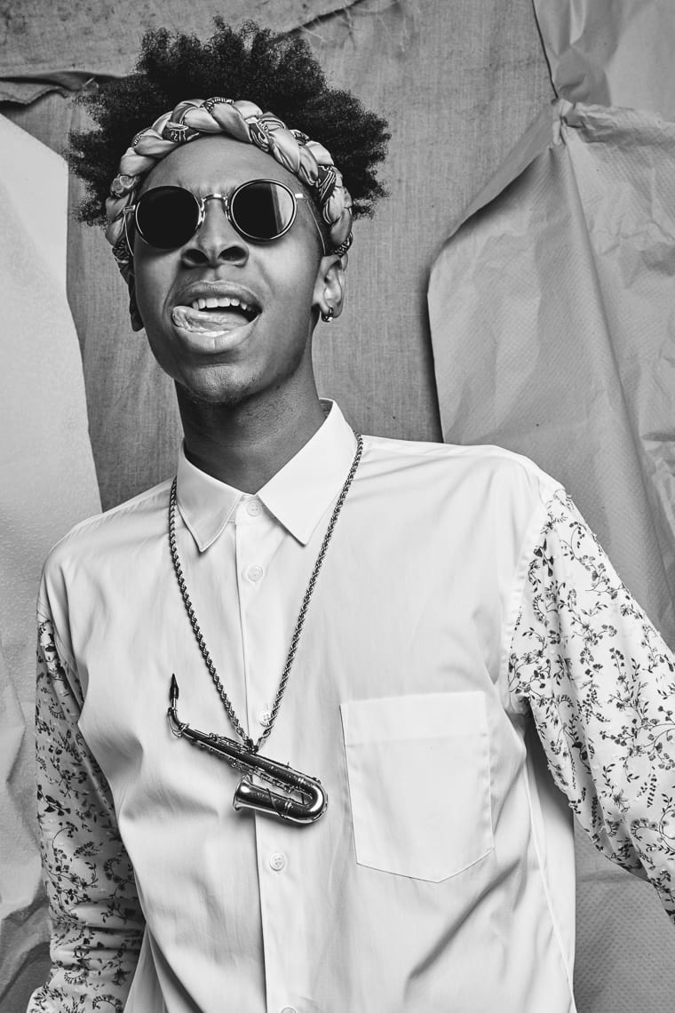 Uncreative Music Artist Profile Masego Black and white of African American man posing for camera wearing shades and headband