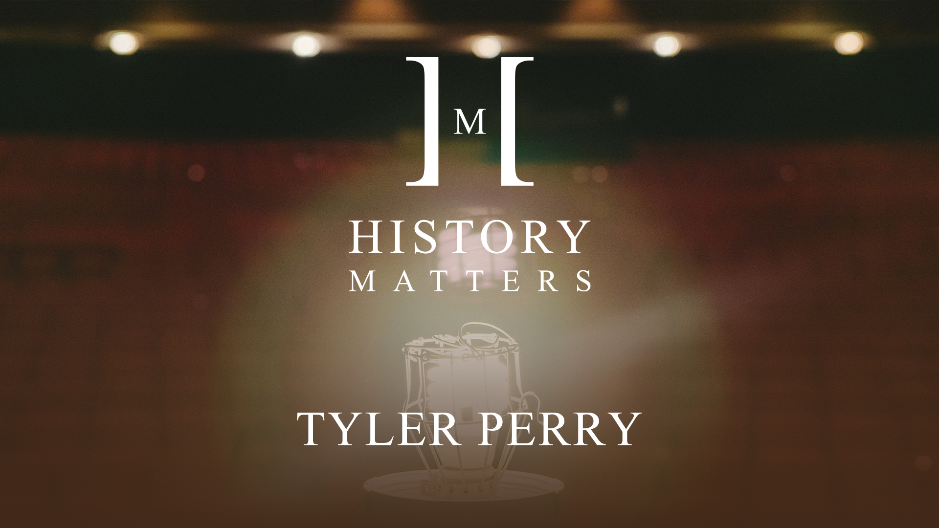 White History Matters Tyler Perry by Amber Fox logo with dimmed background of red theater seats