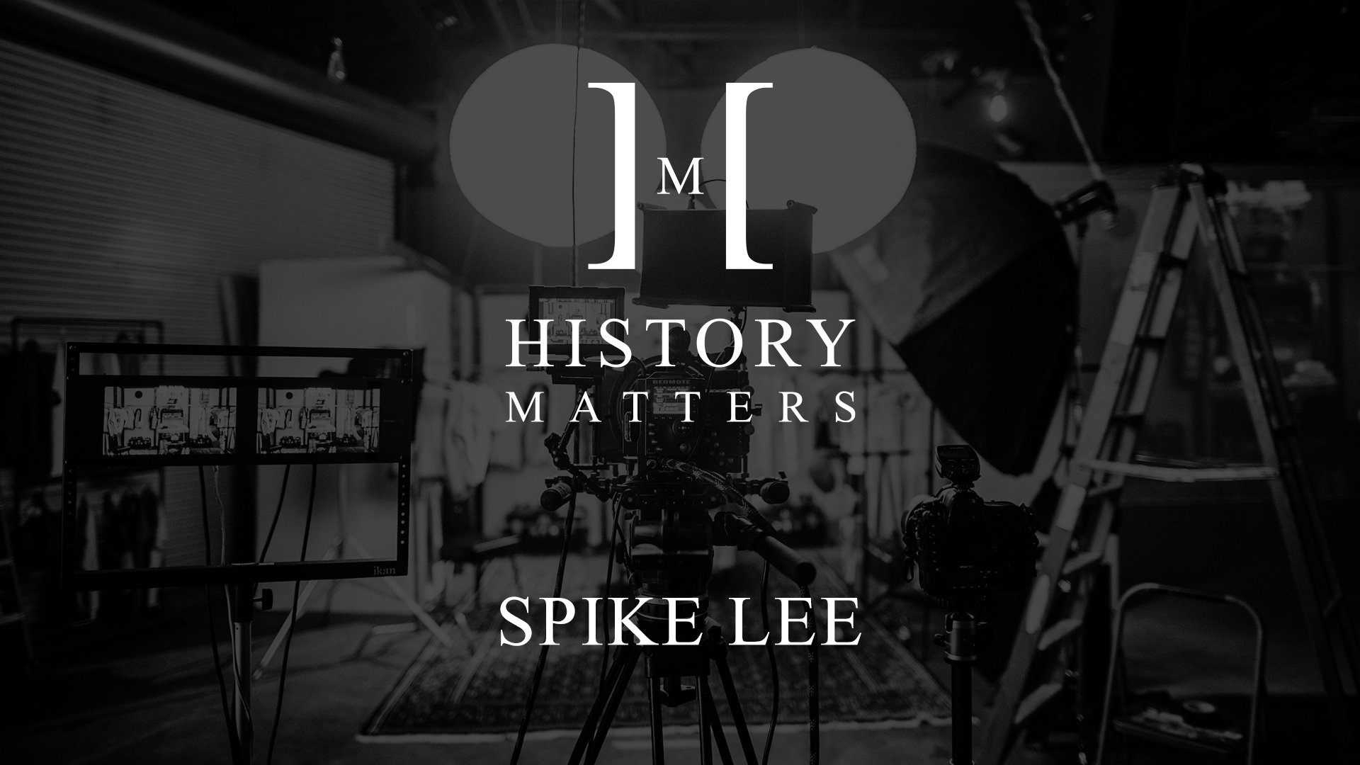 IU C&I Studios Page White History Matters Spike Lee by Angelica Givens logo with dimmed black and white background of a studio with video equipment