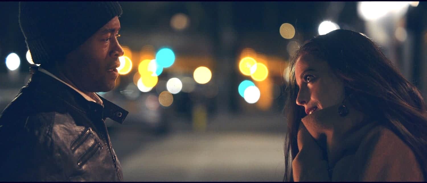 Christmas Eve Movie Side profile of African American man talking and looking at woman