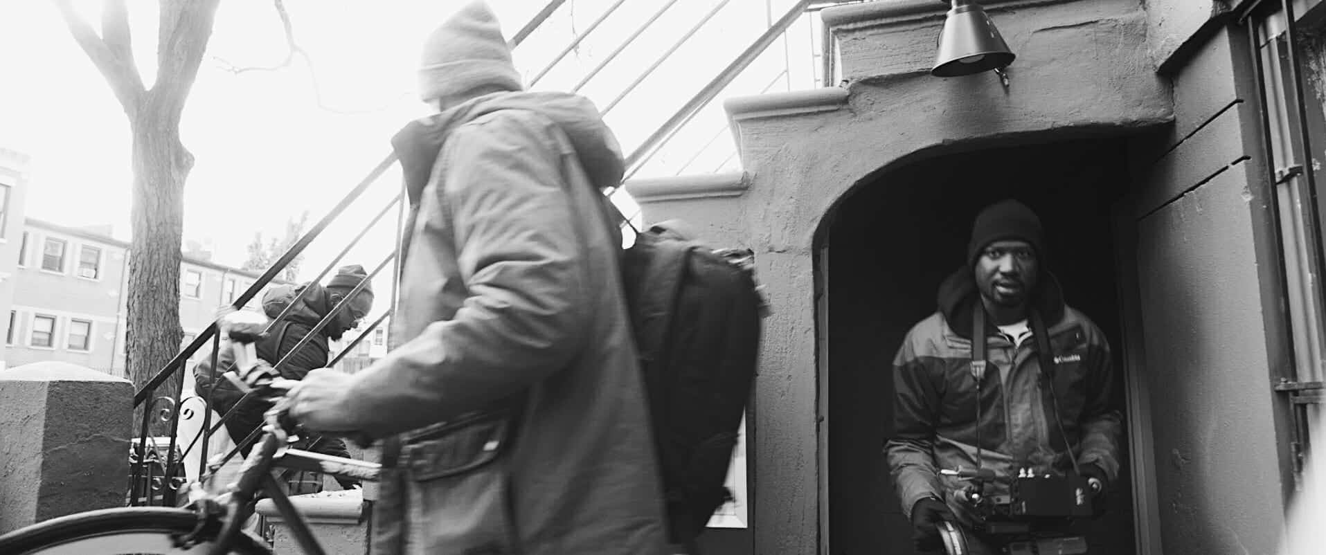 Black and white of African American man in a doorway under steps