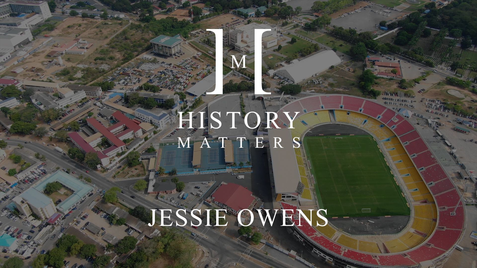 White History Matters Jessie Owens logo with dimmed background aerial view of buildings, tennis courts and stadium