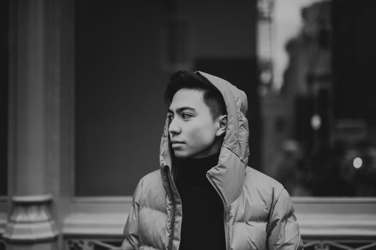 Original Photography for Off-White clothing by C&I Studios Black and white of man with short hair wearing a jacket with hood on his head posing for the camera
