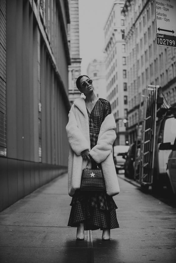 NYFW Off-White Clothing Black and white of woman posing for camera wearing plush coat