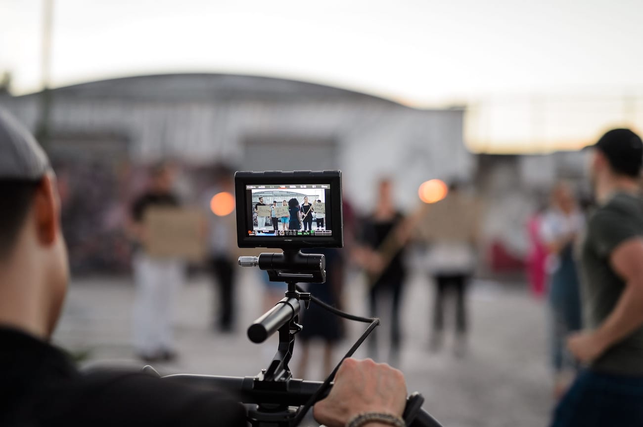 IU C&I Studios Portfolio OneUnited BTS 30 Advertising Agency in Fort Lauderdale Video cameraman filming a group of people