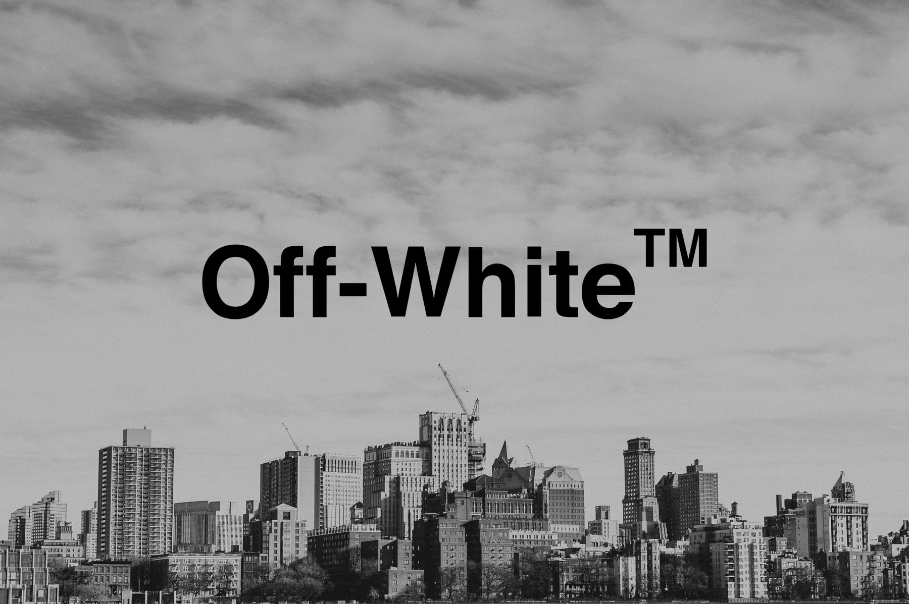 Black and white of black Off White logo with a city under construction scene in the background