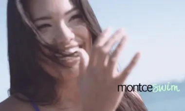 Headshot of woman with long brown hair smiling and posing for camera