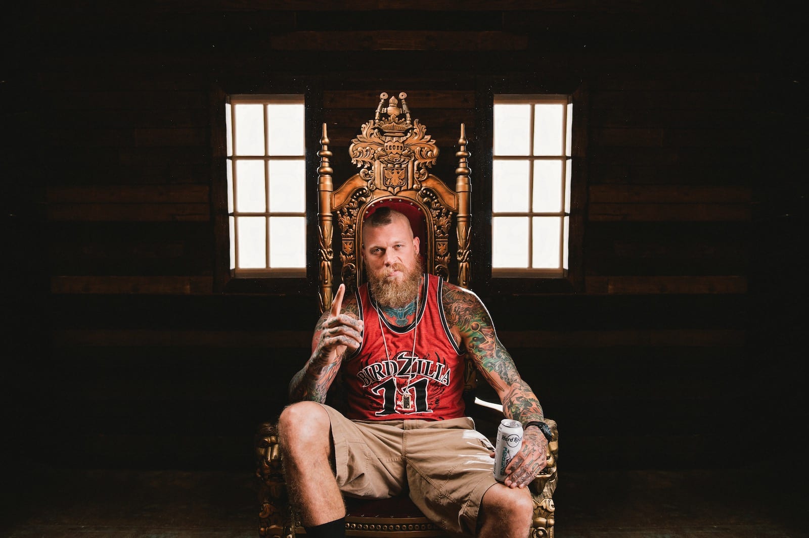 Hard Rock Energy Marketing by C&I Studios Bearded tattooed man sitting on a throne holding a Hard Rock Energy drink posing for camera