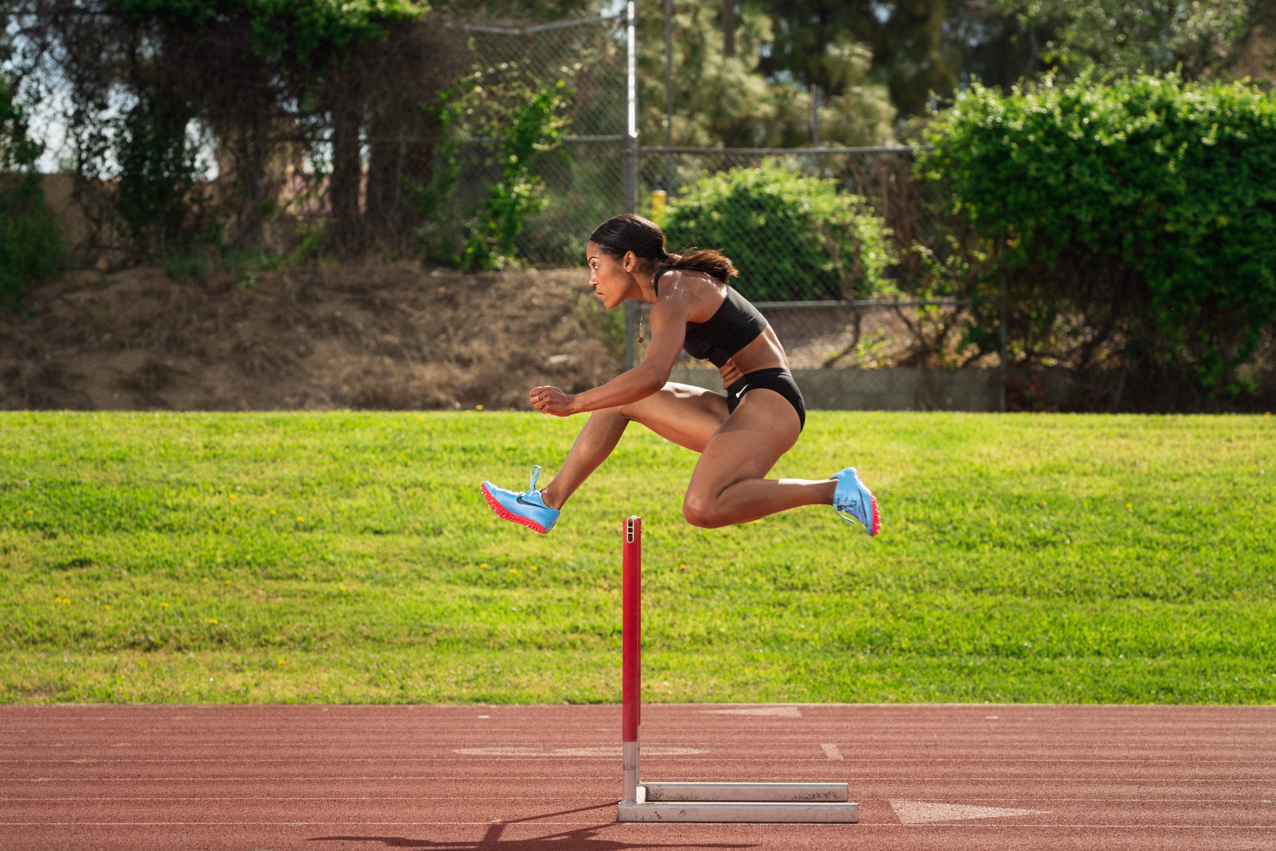 Karelle Edwards Canadian Olympic Athlete jumping a hurdle
