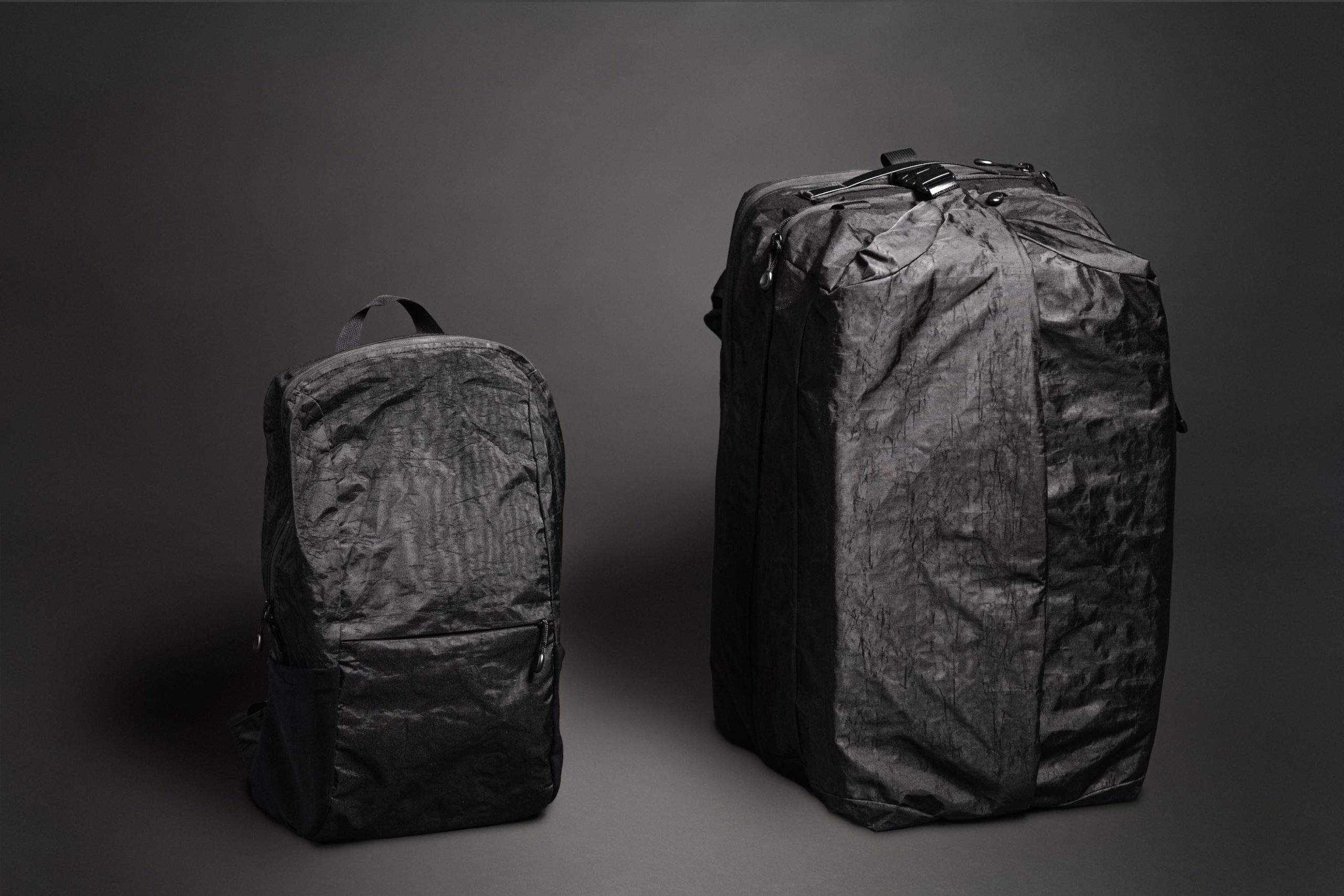 Black Mile Travel Bag Product Photography Small backpack and large black bag on display