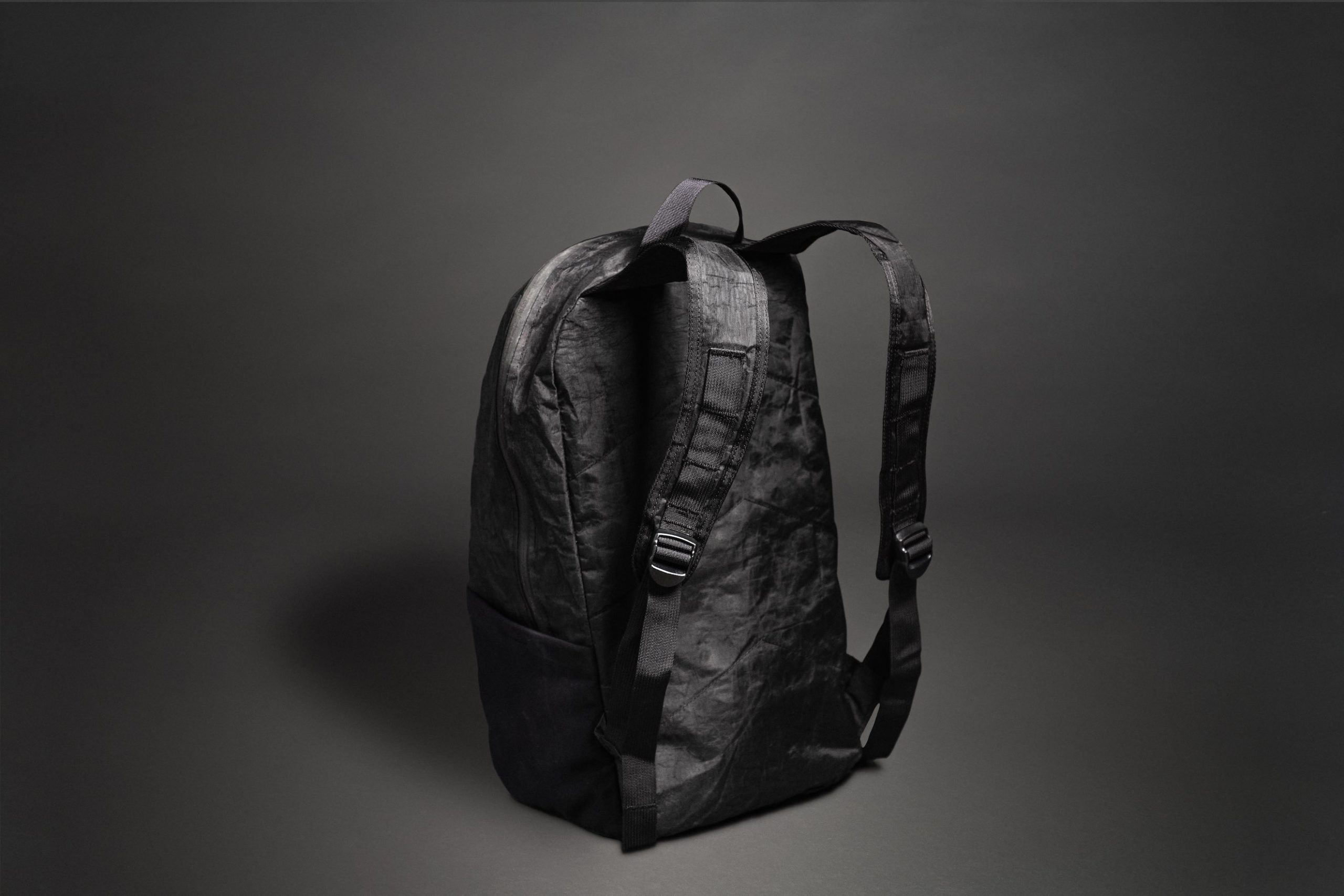 Black Mile Travel Bag Product Photography Side view of a black backpack